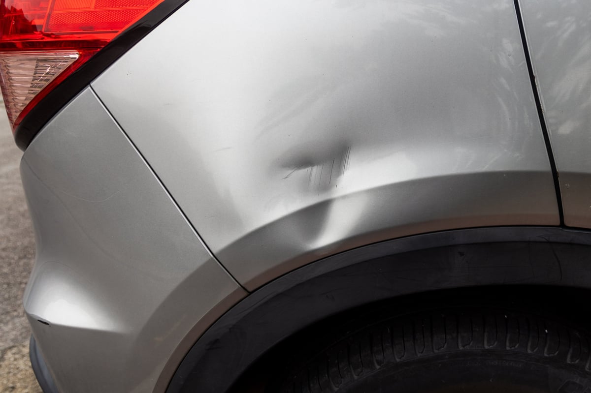 Car body with scratches from accident damage
